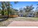 View of backyard with fencing, a small palm tree, and a brick paved area at 3087 Duane Ave, Oldsmar, FL 34677