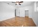 Bright bedroom with hardwood floors, closet, neutral paint, base and crown molding, and ceiling fan at 3087 Duane Ave, Oldsmar, FL 34677