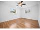 Bright bedroom with hardwood flooring, two windows, and white trim at 3087 Duane Ave, Oldsmar, FL 34677