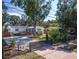 Charming single-story home featuring solar panels, a gravel driveway, and lush landscaping enhancing curb appeal at 3087 Duane Ave, Oldsmar, FL 34677