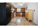 Kitchen with wood cabinets, stone tile floor, stainless appliances, and black countertops at 3087 Duane Ave, Oldsmar, FL 34677