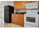Kitchen with wood cabinets, granite countertops, and white appliances at 3087 Duane Ave, Oldsmar, FL 34677