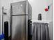 Laundry Room featuring stainless refrigerator and sink with curtain at 3087 Duane Ave, Oldsmar, FL 34677