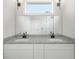 Bright bathroom featuring a double vanity with granite counters and modern fixtures at 3801 Luma Dr, Holiday, FL 34691
