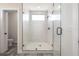 Bathroom with a glass shower enclosure featuring white tile and modern matte black hardware at 3801 Luma Dr, Holiday, FL 34691