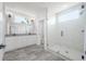 Bright bathroom featuring double vanity sinks, a glass shower, and modern fixtures at 3801 Luma Dr, Holiday, FL 34691