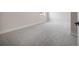Bright bedroom featuring neutral carpet, white trim, and natural light from the window at 3801 Luma Dr, Holiday, FL 34691