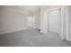 Bedroom with plush carpeting, and an open closet providing easy access to storage at 3801 Luma Dr, Holiday, FL 34691