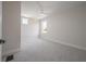 Neutral bedroom with carpet, white trim, and two windows for ample natural light at 3801 Luma Dr, Holiday, FL 34691