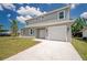 Two-story home featuring a gray exterior, a well-manicured lawn, and an attached single-car garage at 3801 Luma Dr, Holiday, FL 34691