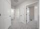 Hallway with neutral paint, white trim, and plush carpeting leading to various rooms at 3801 Luma Dr, Holiday, FL 34691