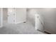 Upstairs hallway featuring neutral carpet, white walls, and multiple doorways to bedrooms and bathrooms at 3801 Luma Dr, Holiday, FL 34691