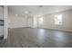 Spacious living room with sleek gray laminate flooring, neutral walls, and natural light from windows at 3801 Luma Dr, Holiday, FL 34691