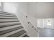 Staircase with gray treads and white risers leading upstairs with a white handrail at 3801 Luma Dr, Holiday, FL 34691