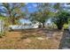 Large backyard with a fire pit and white fencing, perfect for outdoor gatherings and privacy at 4412 W Pearl Ave, Tampa, FL 33611