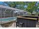 Outdoor patio with bar seating, and the screened-in pool with room for entertaining at 4412 W Pearl Ave, Tampa, FL 33611