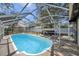Backyard view of a screened-in pool and patio area, ideal for enjoying sunny days at 4412 W Pearl Ave, Tampa, FL 33611