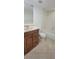 A clean and well-lit bathroom featuring a tub and a wooden vanity at 4725 Michael Ct # 131, Tampa, FL 33614