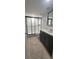 Updated bathroom featuring a glass shower door and tile flooring at 4725 Michael Ct # 131, Tampa, FL 33614