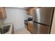 Bright kitchen featuring stainless steel refrigerator, range, countertops, and ample cabinet space at 4725 Michael Ct # 131, Tampa, FL 33614