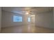 Bright and airy living room with tile flooring, ceiling fan and natural light from two windows at 4725 Michael Ct # 131, Tampa, FL 33614
