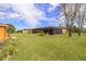 Sprawling backyard with an enclosed lanai and lush lawn, ideal for outdoor entertaining and relaxation at 14739 Vista View Ct, Dade City, FL 33523