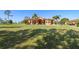 Expansive front yard with a well-maintained lawn and a charming home in the background at 14739 Vista View Ct, Dade City, FL 33523