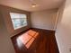 Bedroom with hardwood floors, a large window for natural light, and neutral walls at 1621 Fluorshire Dr, Brandon, FL 33511