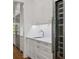 Wet bar with white cabinets, stainless appliances and marble countertops at 4614 W Tennyson Ave, Tampa, FL 33629