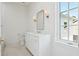 A bright bathroom featuring a vanity and view from the window at 4614 W Tennyson Ave, Tampa, FL 33629