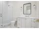 Bathroom with glass enclosed shower and white cabinets at 4614 W Tennyson Ave, Tampa, FL 33629