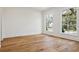 Bright, airy bedroom with hardwood floors and large windows offering ample natural light at 4614 W Tennyson Ave, Tampa, FL 33629