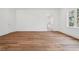 A large bedroom with wood floors, white walls, and natural light coming through a window at 4614 W Tennyson Ave, Tampa, FL 33629