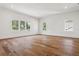 Spacious bedroom featuring hardwood floors and natural light from the windows at 4614 W Tennyson Ave, Tampa, FL 33629