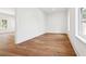 Bedroom with hardwood floors and natural light from the window at 4614 W Tennyson Ave, Tampa, FL 33629