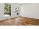 Bright, airy bedroom with hardwood floors and large windows offering ample natural light at 4614 W Tennyson Ave, Tampa, FL 33629