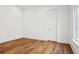 A bright bedroom with hardwood floors, white walls, and natural light from the window at 4614 W Tennyson Ave, Tampa, FL 33629