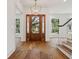 Stunning foyer with hardwood floors, elegant lighting, and a beautiful wood front door at 4614 W Tennyson Ave, Tampa, FL 33629