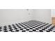Hallway with striking black and white checkered tile flooring and white trim at 4614 W Tennyson Ave, Tampa, FL 33629