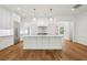 Bright kitchen features a large center island, stainless steel appliances, and white cabinetry at 4614 W Tennyson Ave, Tampa, FL 33629