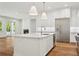 Spacious kitchen with island, stainless steel appliances and light, modern finishes at 4614 W Tennyson Ave, Tampa, FL 33629