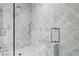 Luxurious shower featuring stylish tile work and a glass enclosure at 4614 W Tennyson Ave, Tampa, FL 33629