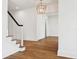 Bright staircase featuring hardwood floors, white risers, and a stylish black handrail at 4614 W Tennyson Ave, Tampa, FL 33629