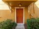 Close-up of the front door showcasing the house number and well-maintained entrance with manicured shrubs at 4734 Chatterton Way, Riverview, FL 33578