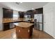 Beautiful kitchen featuring stainless steel appliances, granite countertops, large island, and dark wood cabinets at 4734 Chatterton Way, Riverview, FL 33578