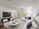 Open living room with white sectional, stylish decor, and ample natural light, perfect for relaxation at 4734 Chatterton Way, Riverview, FL 33578
