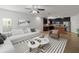 Spacious living room with a view of the kitchen, features comfortable seating and modern decor at 4734 Chatterton Way, Riverview, FL 33578