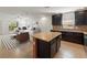 Open-concept living and kitchen area with dark cabinets and bright white walls at 4734 Chatterton Way, Riverview, FL 33578
