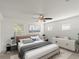 Bright and spacious main bedroom featuring neutral colors, ceiling fan, and ample natural light at 4734 Chatterton Way, Riverview, FL 33578