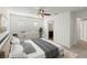 Spacious main bedroom with ceiling fan and a glimpse into the en suite bathroom at 4734 Chatterton Way, Riverview, FL 33578